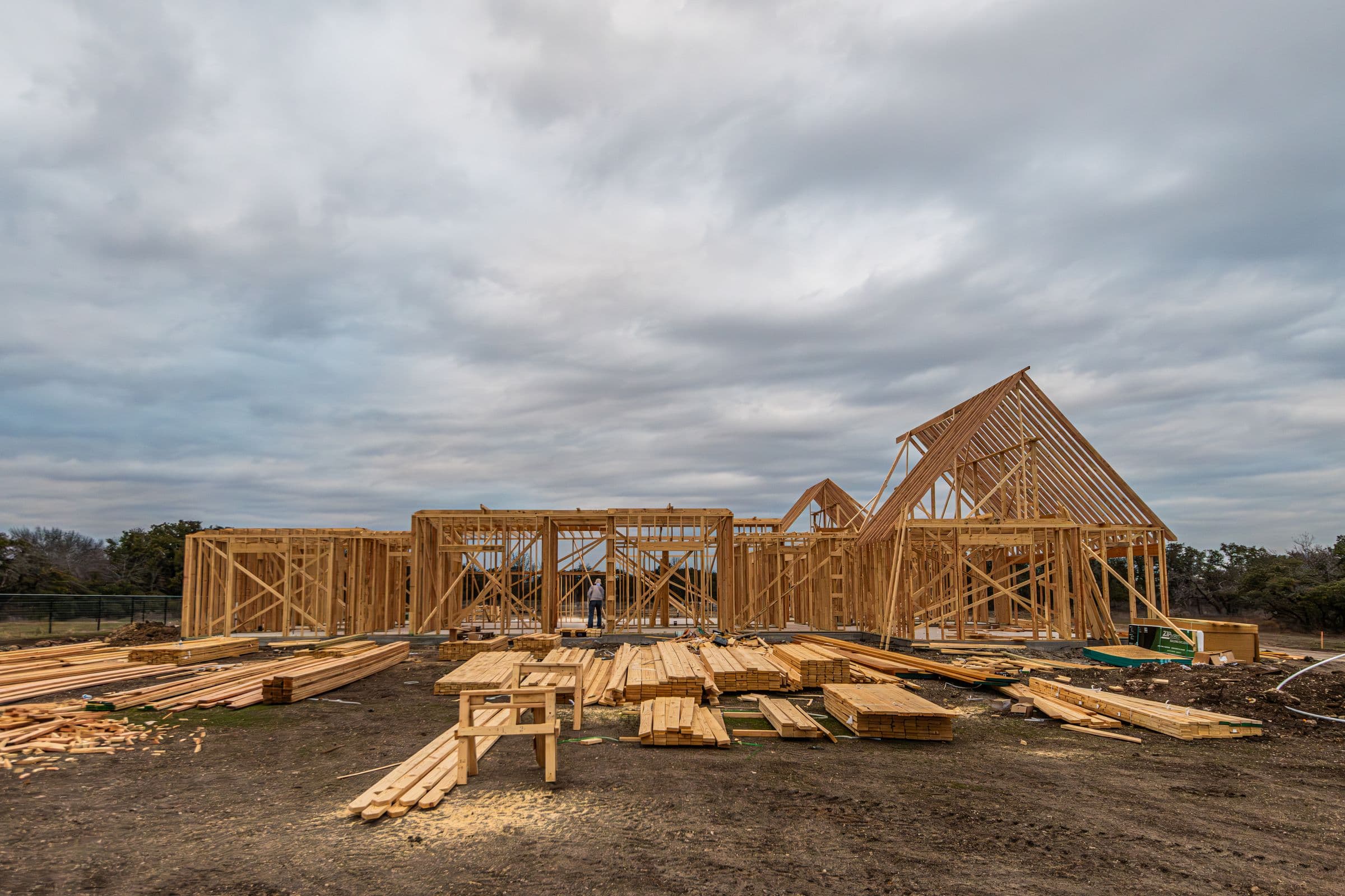 House framing on a jobsite under a wide sky.